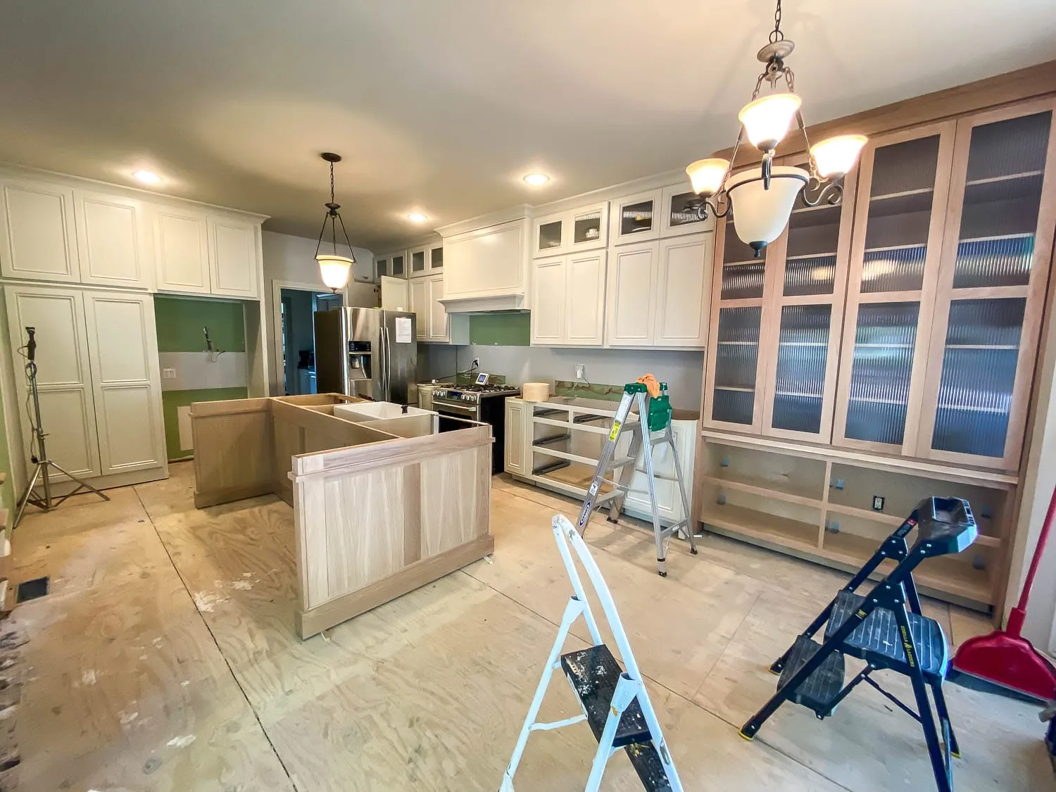 Kitchen remodel in progress with new cabinets set and an island going in